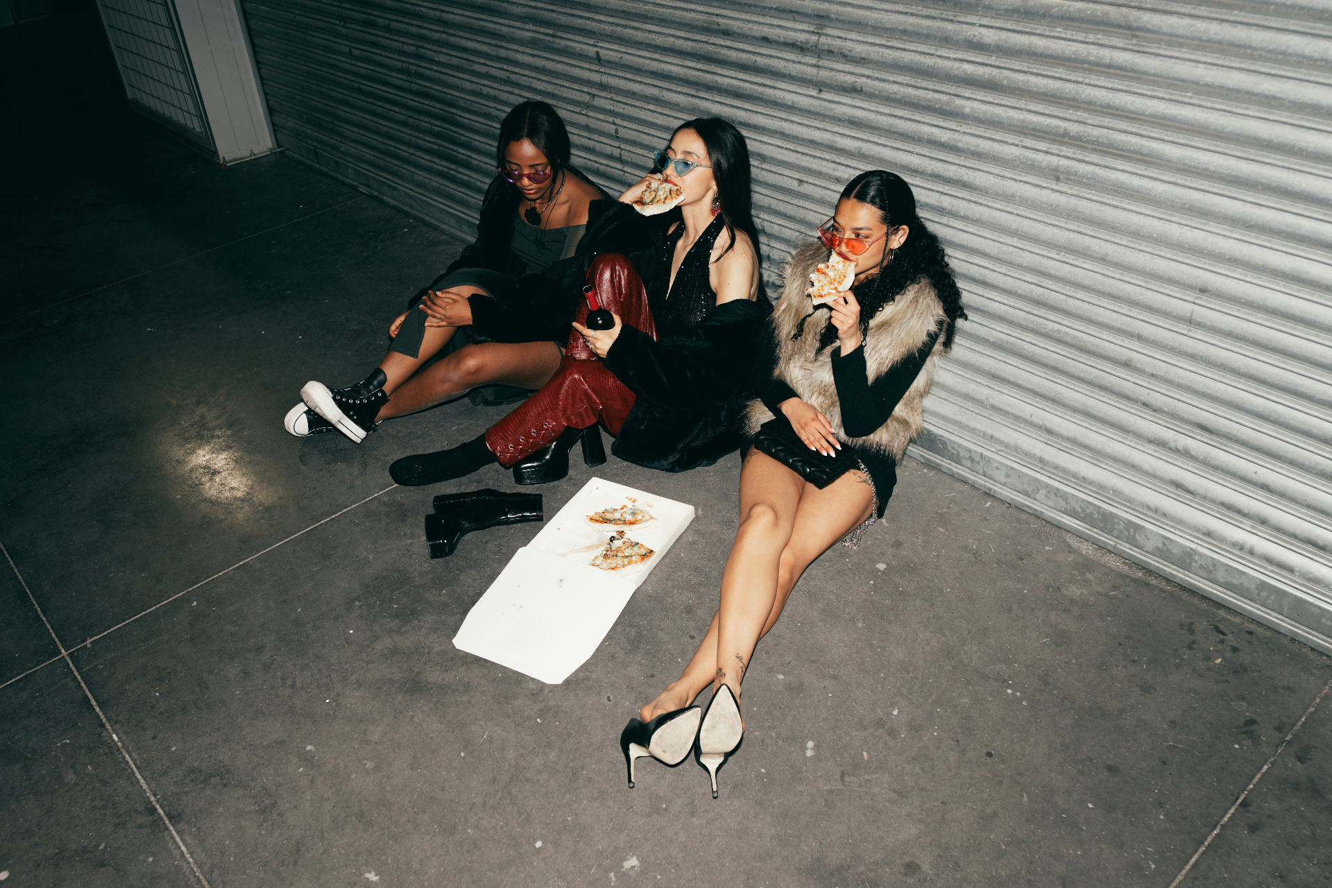 friends sharing pizza on the street